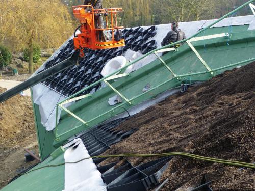 Materials for the green roof system build-up are lifted onto the roof